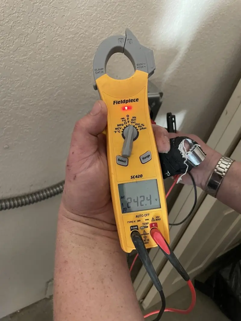 Voltage testing with clamp meter during Electrical Installation Services in Angola
